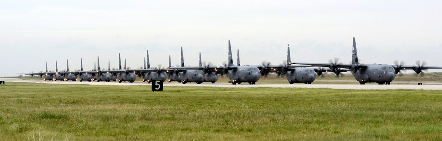 U.S. Air Force C-130J Super Hercules roll down the runway June 21, 2014, on Dyess Air Force Base, Texas. 21 C-130 models from multiple Air Force installations participated in a Joint Forcible Entry exercise at Nellis Air Force Base, Nev. (U.S. Air Force photo by Staff Sgt. Richard Ebensberger/Released)

