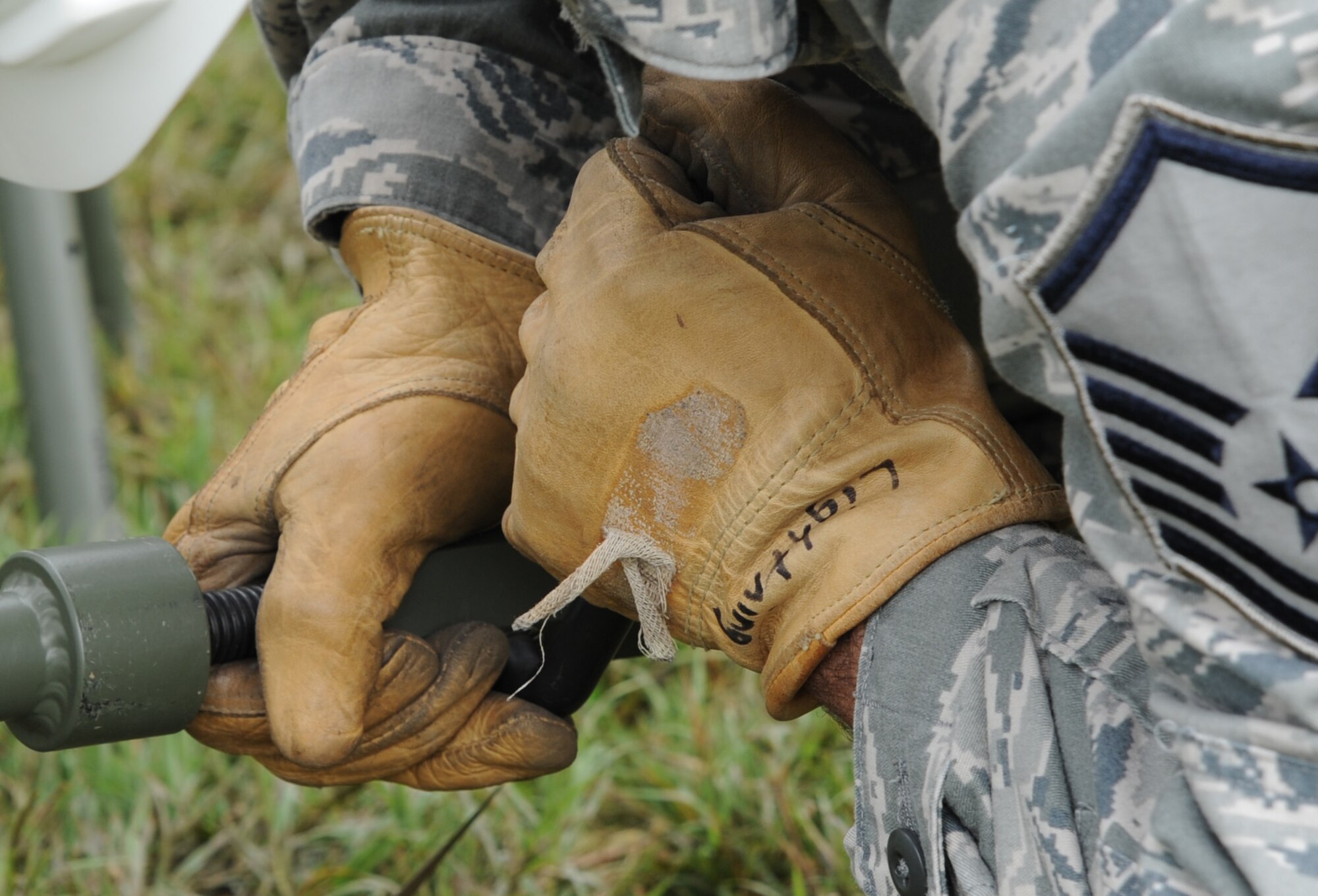 Master Sgt. Ervin Lockhart, 239th Combat Communications Squadron NCO in-charge of radio frequency transmissions, tightens a rod while building a satellite at Whiteman Air Force Base, Mo., June 11, 2014. The 239th CCS can also provide the same types of communications to civil authorities in case of a major incident or natural disaster. (U.S. Air Force photo by Senior Airman Bryan Crane/released)