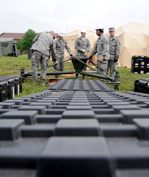 Members of the 239th Combat Communications Squadron review the beginning steps of their satellite during a simulated deployment to Whiteman Air Force, Mo., June 11, 2014. The 239th CCS is based at Jefferson Barracks, Mo. (U.S. Air Force photo by Senior Airman Bryan Crane/released)