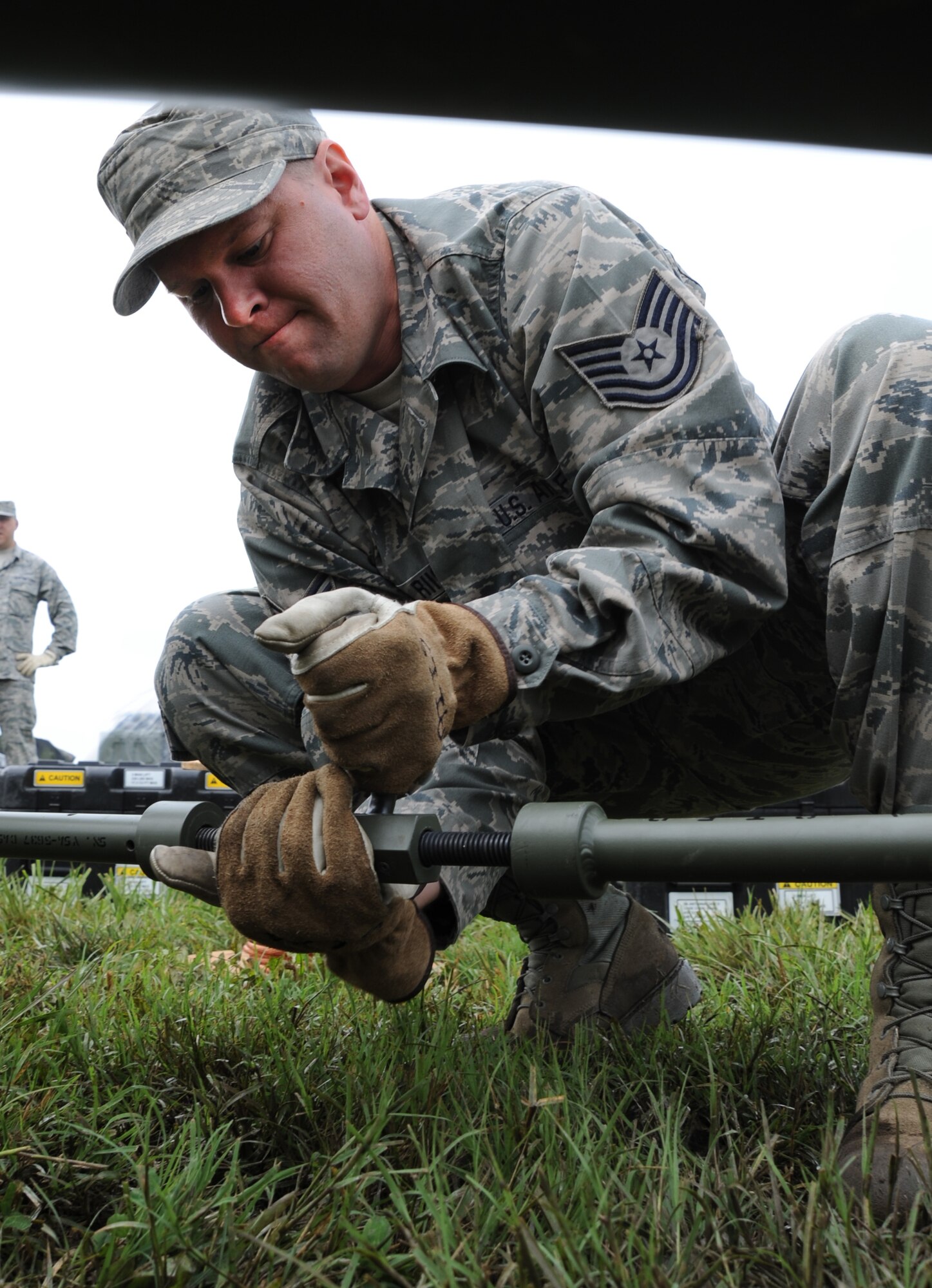 Tech. Sgt. Russell Riis, 239th Combat Communications Squadron radio frequency transmissions craftsman, tightens a component of a satellite during a simulated deployment to Whiteman Air Force, Mo., June 11, 2014. The 239th CCS can provide secure and non-secure internet as well as 300 phones and network defense systems. (U.S. Air Force photo by Senior Airman Bryan Crane/released)