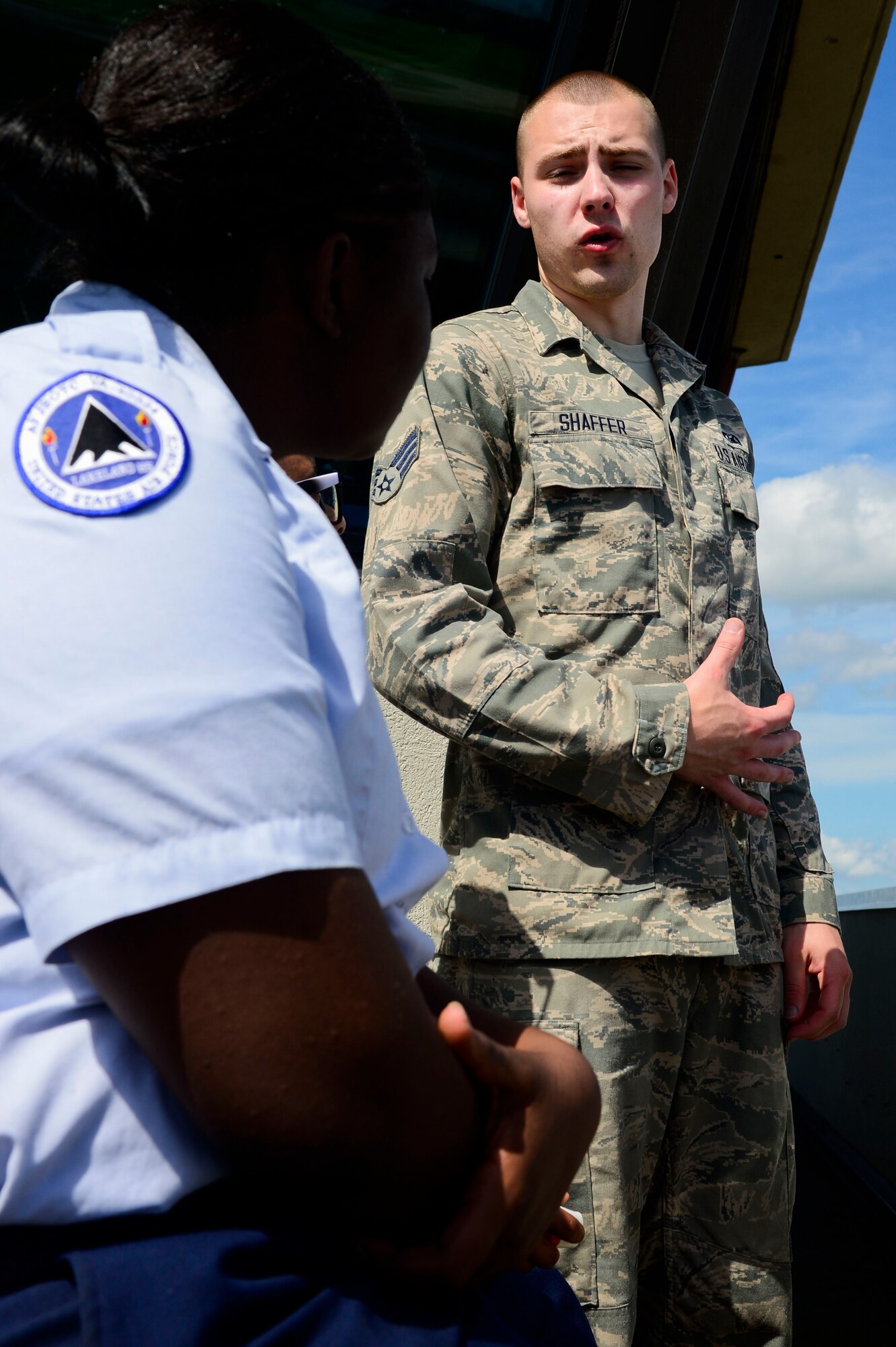 U.S. Air Force Senior Airman Joshua Shaffer, 1st Operations Support Squadron air traffic controller, explains the mission of the 1st OSS air traffic control tower to an Air Force Junior ROTC cadet during Shadow Day at Langley Air Force Base, Va., June 24, 2014. During a week-long summer leadership program, 80 cadets joined Airmen to learn about the Air Force mission. (U.S. Air Force photo by Senior Airman Kayla Newman/Released) 