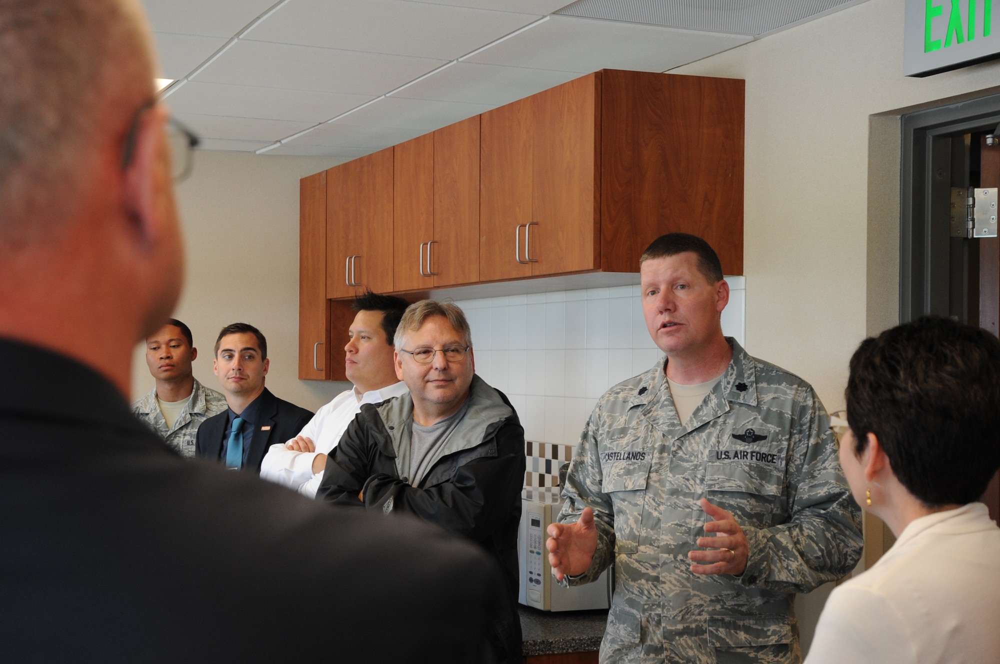 Lt. Col. Jonathan Castellanos, 319th Operations Support Squadron commander, speaks to a group of community and business leaders from the greater Grand Forks area, June 24, 2014, in the air traffic control tower on Grand Forks Air Force Base, N.D. The group was attending the Unmanned Aerial Systems Summit held in the city of Grand Forks and visited the base for a brief tour of the proposed site of the Grand Sky business park. (U.S. Air Force photo/Staff Sgt. David Dobrydney)