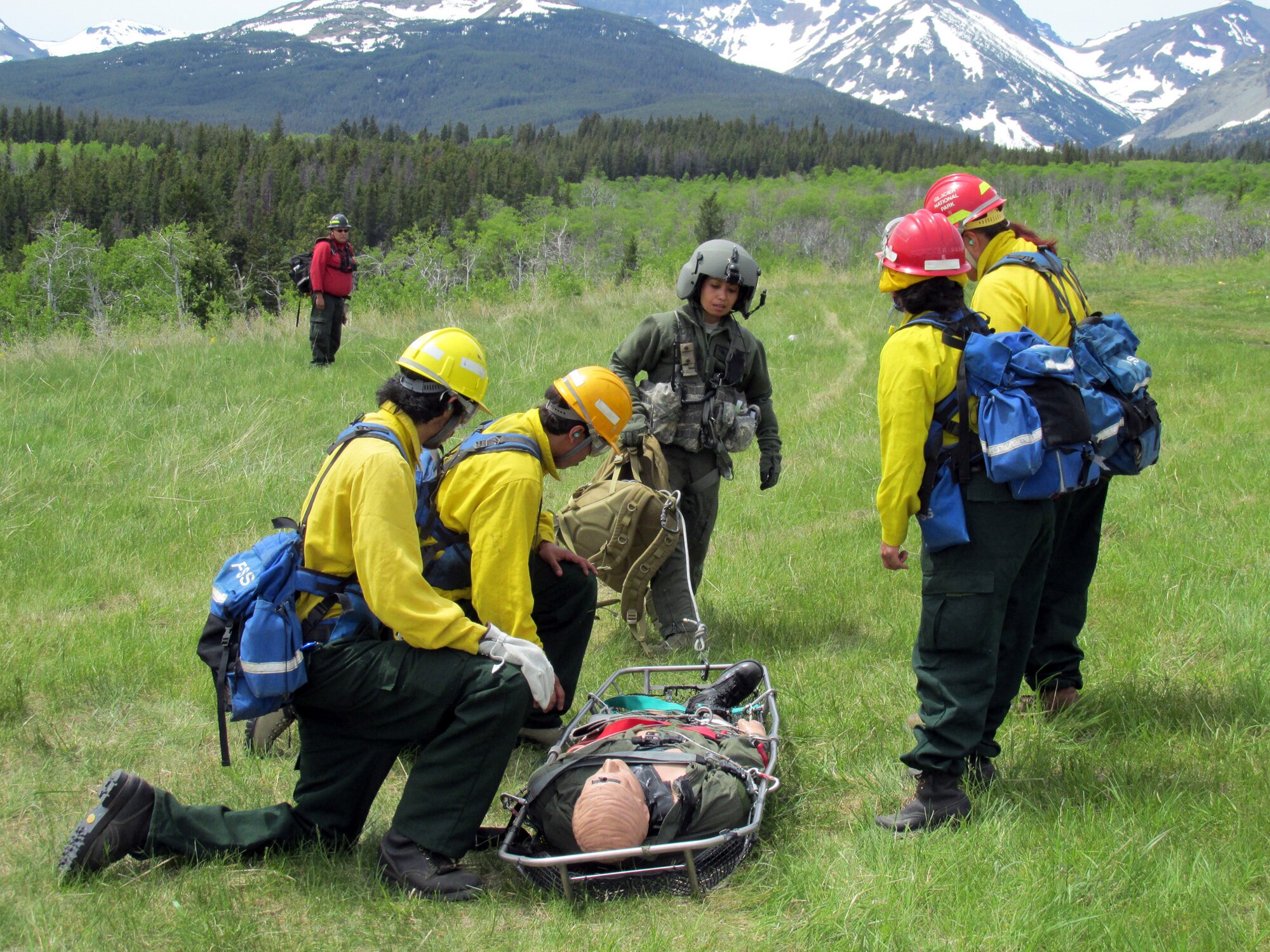 Maj. Rhodora Beckinger, 341st Medical Operations Squadron flight surgeon, shows firefighters Tyson Trombley, Robert Thomas, Kendra Bullshoe and Leona Tracey how to use the Stokes litter for patient exfiltration by helicopter. Ground training included helicopter safety, helicopter loading/unloading, search and rescue principles and use of rescue devices to include a forest penetrator and a Stokes litter. (Courtesy Photo)