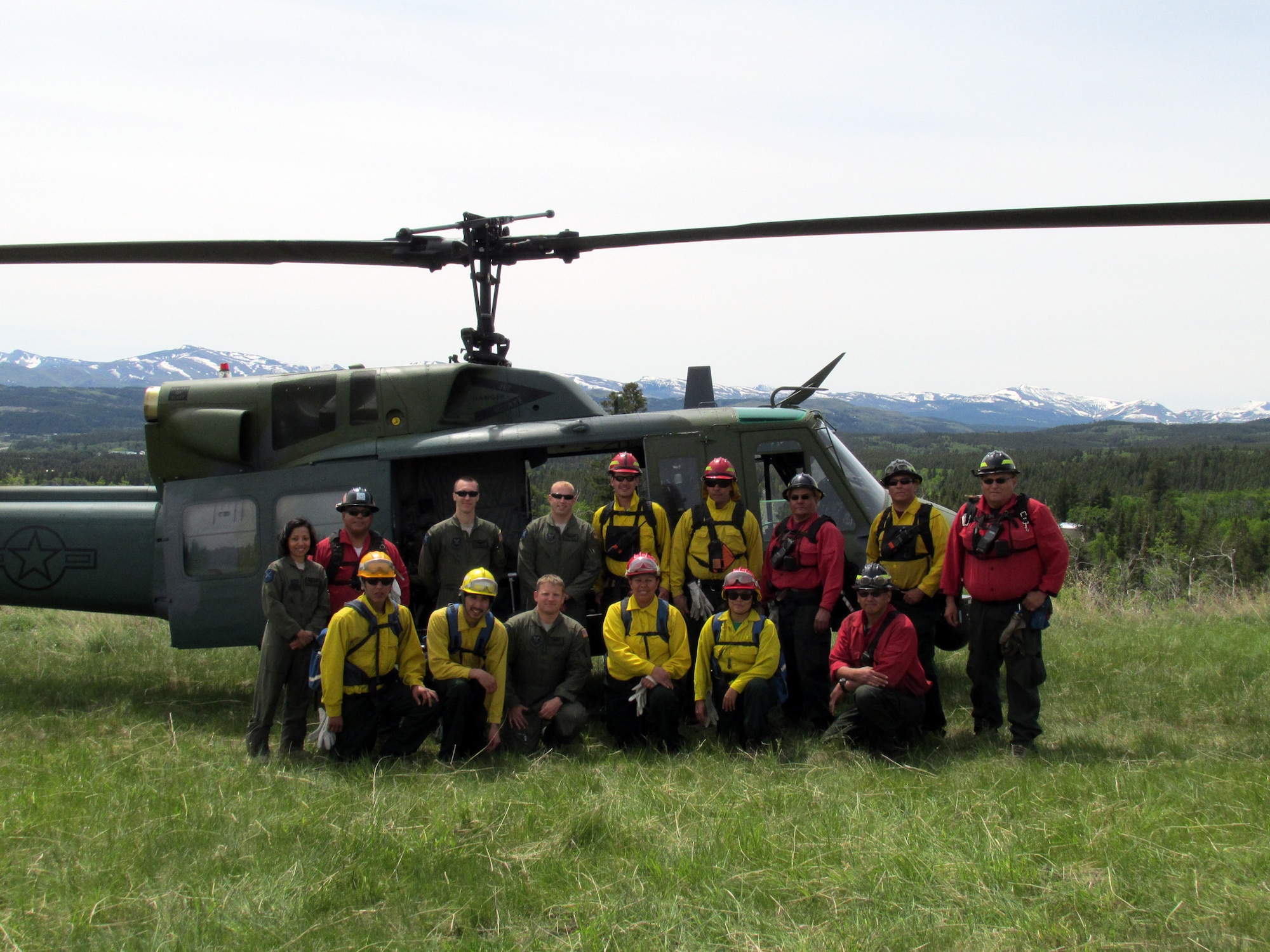 Crewmembers of Blade 99 pose with Blackfeet firefighters in front of a Malmstrom Air Force Base UH-1N helicopter on June 12. Members from the 40th Helicopter Squadron and 341st Medical Group joined the Blackfeet Fire Management crew for a training exercise in East Glacier National Park. (Courtesy Photo)