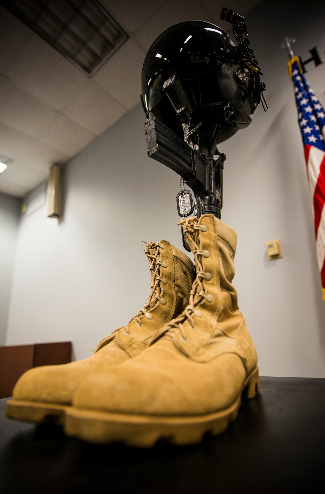 A traditional display of boots, dog tags, M-16 rifle and kevlar helmet is set up as a memorial during a Khobar Towers remembrance ceremony at Moody Air Force Base, Ga., June 25, 2014. The ceremony honored the 19 service members who died during the attack 18 years ago. (U.S. Air Force photo by Senior Airman Douglas Ellis/Released)
