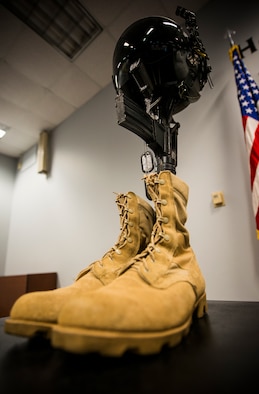 A traditional display of boots, dog tags, M-16 rifle and kevlar helmet is set up as a memorial during a Khobar Towers remembrance ceremony at Moody Air Force Base, Ga., June 25, 2014. The ceremony honored the 19 service members who died during the attack 18 years ago. (U.S. Air Force photo by Senior Airman Douglas Ellis/Released)
