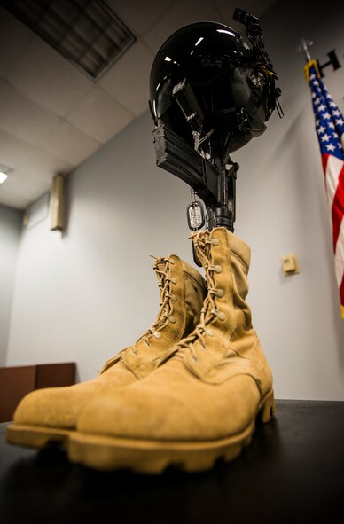 A traditional display of boots, dog tags, M-16 rifle and kevlar helmet is set up as a memorial during a Khobar Towers remembrance ceremony at Moody Air Force Base, Ga., June 25, 2014. The ceremony honored the 19 service members who died during the attack 18 years ago. (U.S. Air Force photo by Senior Airman Douglas Ellis/Released)
