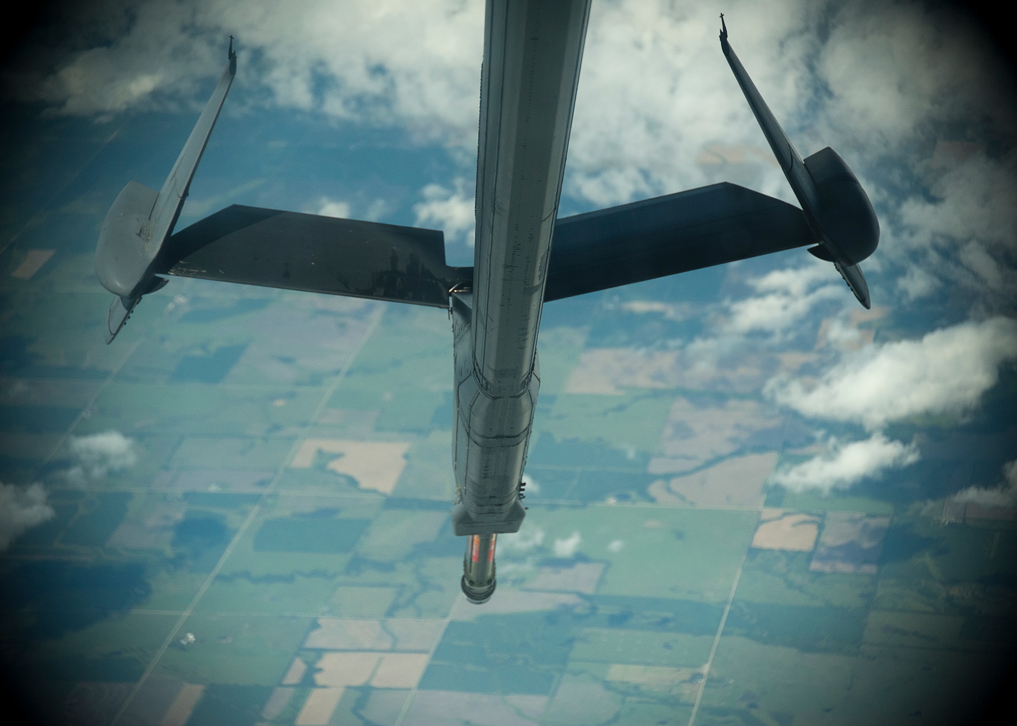 The boom from a KC-10 extender is lowered, as an air crew from the 76th Air Refueling Squadron, 514th Air Mobility Wing, prepares to refuel three B-2A Bombers during a training mission over the Midwest June 19. The KC-10 can carry 356,000 pounds of fuel, 170,000 pounds of cargo and up to 75 personnel.  (U.S. Air Force photo/Christian DeLuca