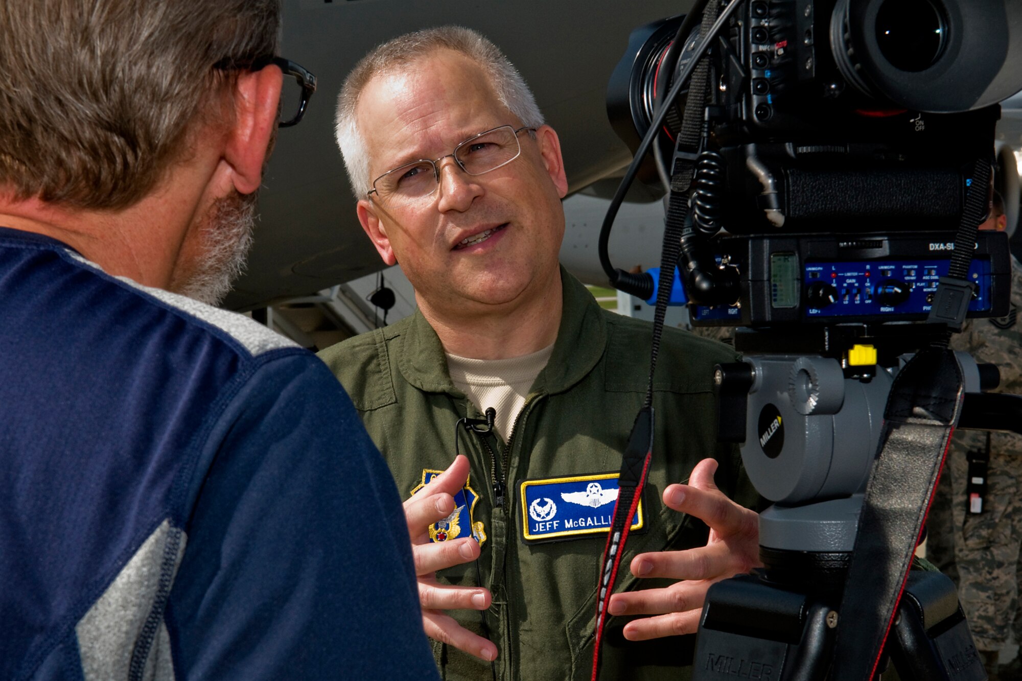Col. Jeff McGalliard, 445th Airlift Wing commander, is interviewed by Tyler Greenlees, Dayton Daily News chief photographer, at Wright-Patterson Air Force Base, Ohio, before the two boarded a 434th Air Refueling Wing KC-135R Stratotanker aircraft during a training mission and media flight over Kentucky June 18, 2014. The 434th ARW is the largest KC-135R unit in the Air Force Reserve Command, and the 445th AW C-17 flies the newest and most flexible cargo aircraft in the airlift force. (U.S. Air Force photo/Senior Airman Jami K. Lancette)