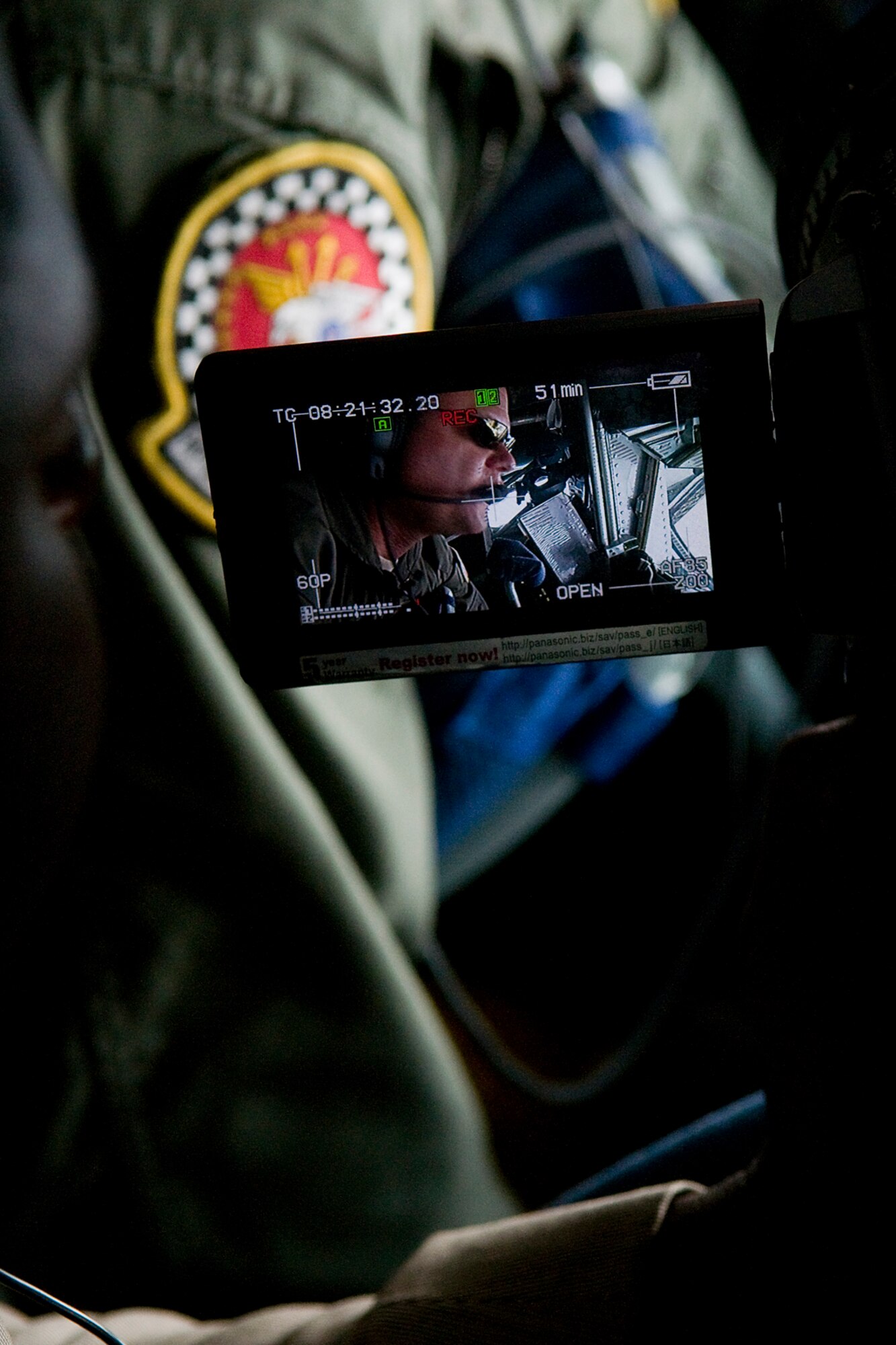 Wale Aliyu, a reporter from Dayton, Ohio?s, ABC 22 and FOX 45, films Master Sgt. Christopher Nack, 74th Air Refueling Squadron boom operator, onboard a 434th Air Refueling Wing KC-135R Stratotanker aircraft during a training mission and media flight over Kentucky June 18, 2014. The main mission of the KC-135 is to provide inflight refueling to long-range bomber, fighter and cargo aircraft. (U.S. Air Force photo/Senior Airman Jami K. Lancette)