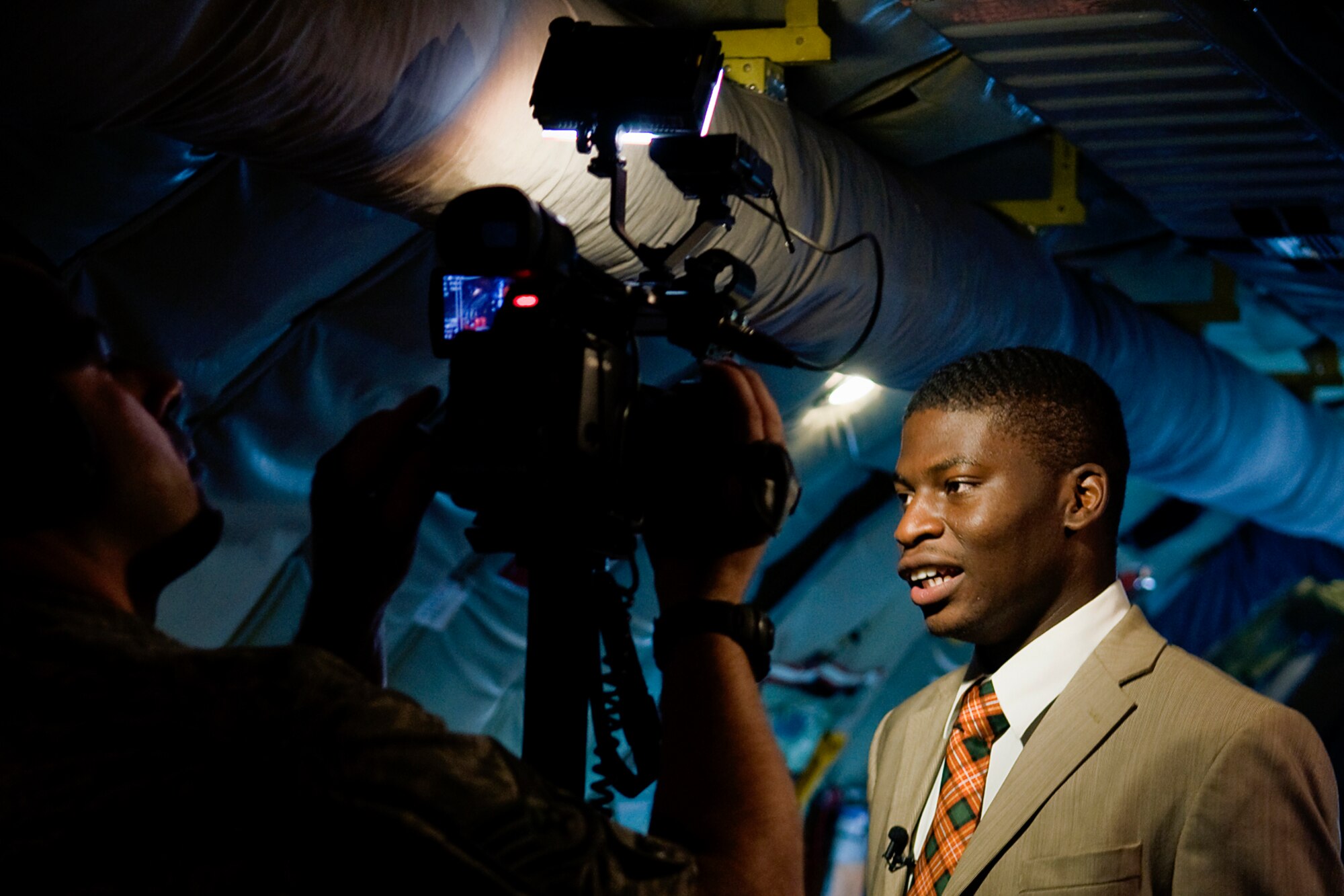 Wale Aliyu, a reporter from Dayton, Ohio?s, ABC 22 and FOX 45, is filmed by Staff Sgt. Scott Johnson, 88th Air Base Wing public affairs specialist, onboard a 434th Air Refueling Wing KC-135R Stratotanker aircraft during a training mission and media flight over Kentucky June 18, 2014. The 88th ABW PA office took part in the flight to cover a combined media flight hosted by both the 434th ARW from Grissom Air Reserve Base, Ind., and the 445th Airlift Wing at Wright-Patterson Air Force Base, Ohio. (U.S. Air Force photo/Senior Airman Jami K. Lancette)