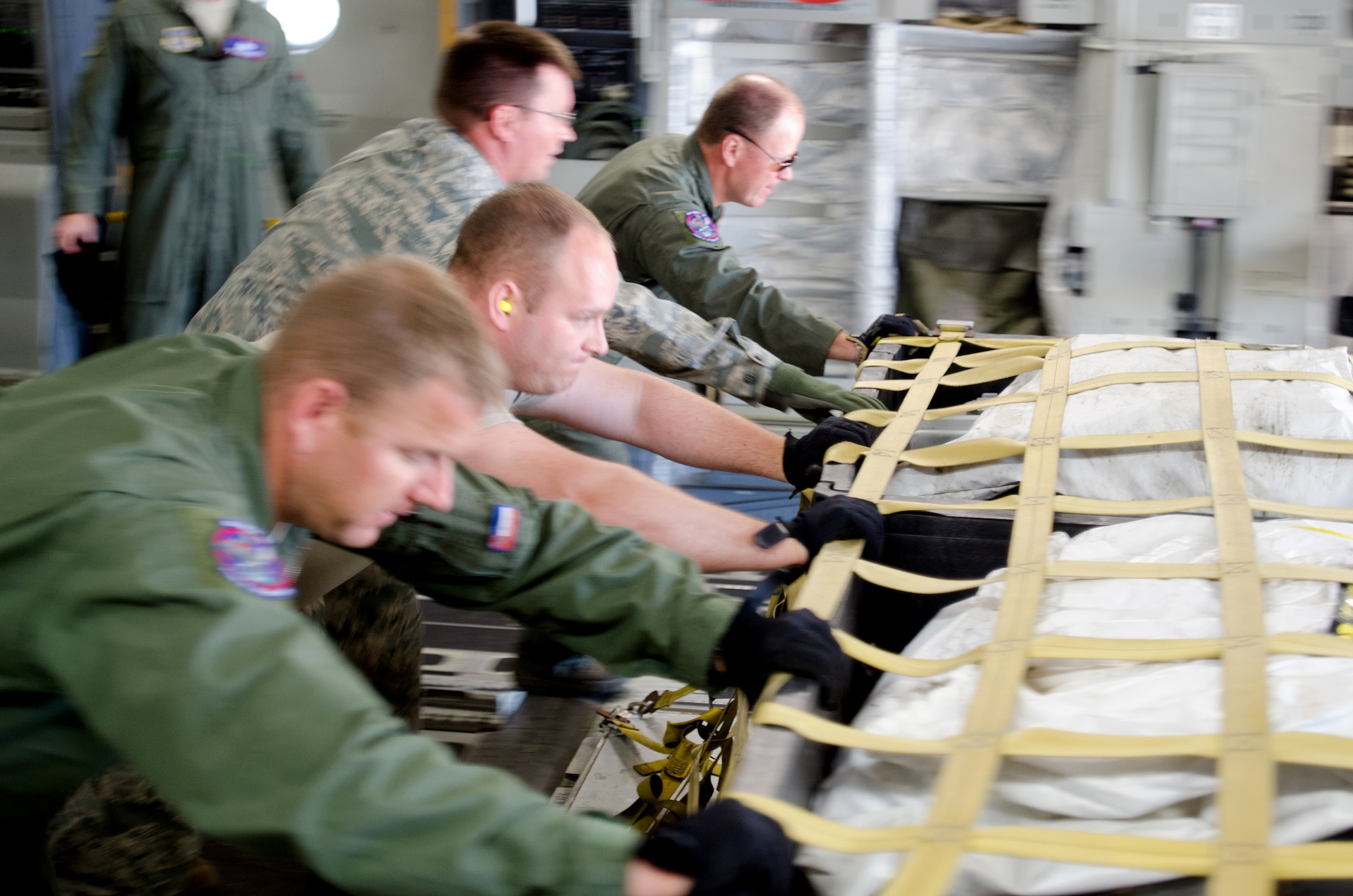 Personnel from the Kentucky Air National Guard’s 123rd Contingency Response Group push cargo off of a Mississippi Air National Guard C-17 Globemaster during disaster-response exercise CAPSTONE ’14 at Fort Campbell, Ky., June 17, 2014. The 123rd CRG joined forces with the U.S. Army’s 688th Rapid Port Opening Element to operate a Joint Task Force-Port Opening here from June 16 to 19, 2014. (U.S. Air National Guard photo by Master Sgt. Phil Speck)