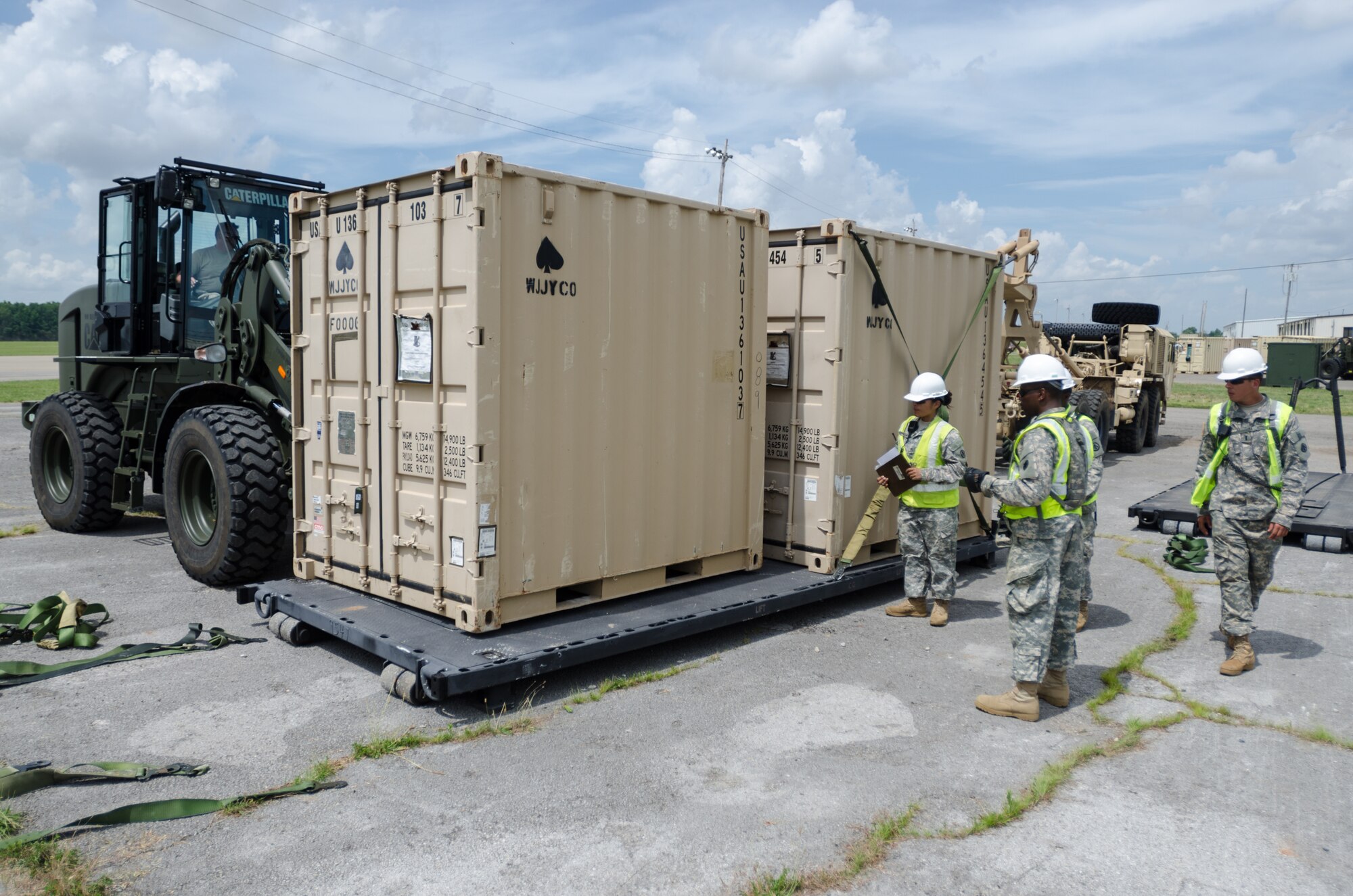 Soldiers from the U.S. Army’s 688th Rapid Port Opening Element inspect cargo on June 18, 2014, before strapping it down for transport to a staging area called the Forward Node during Capstone '14, a homeland earthquake-response exercise at Fort Campbell, Ky. The 688th RPOE joined forces with the Kentucky Air National Guard’s 123rd Contingency Response Group to operate a Joint Task Force-Port Opening here from June 16 to 19, 2014. (U.S. Air National Guard photo by Master Sgt. Phil Speck)