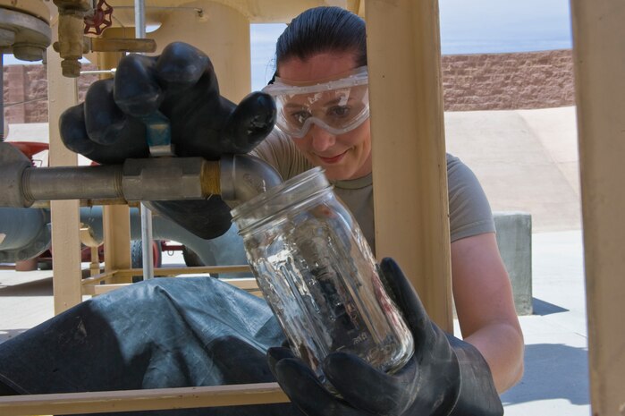 Senior Airman Elizabeth Bingham, 419th Logistics Readiness Squadron fuels journeyman from  Hill Air Force Base, Utah, drains fuel from a fuel tank June 20, 2014, at Nellis AFB, Nev. Members from the 419th LRS, in various career fields such as, supply, traffic and vehicle management, conducted their two week annual training at Nellis. The squadron travels across the world each year for two weeks at a time to stay proficient in their training. (U.S. Air Force photo by Airman 1st Class Monet Villacorte)