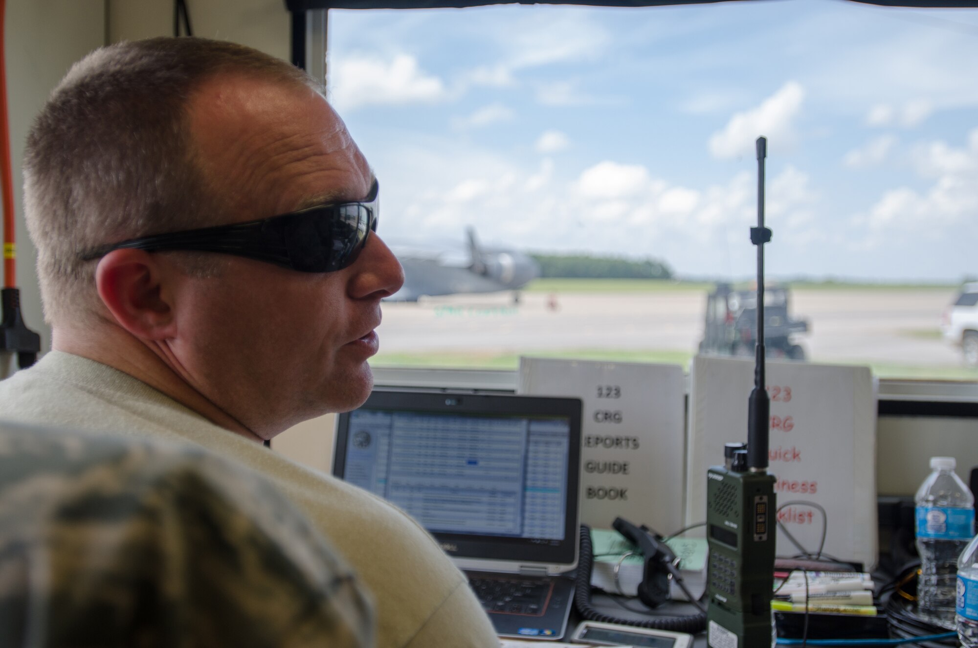 Tech. Sgt. Michael Skeens, command post controller for the Kentucky Air National Guard’s 123rd Contingency Response Group, tracks aircraft on the airfield at Fort Campbell, Ky., June 18, 2014, during Capstone '14, a homeland earthquake-response exercise. The 123rd CRG joined forces with the U.S. Army’s 688th Rapid Port Opening Element to operate a Joint Task Force-Port Opening here from June 16 to 19, 2014. (U.S. Air National Guard photo by Master Sgt. Phil Speck)