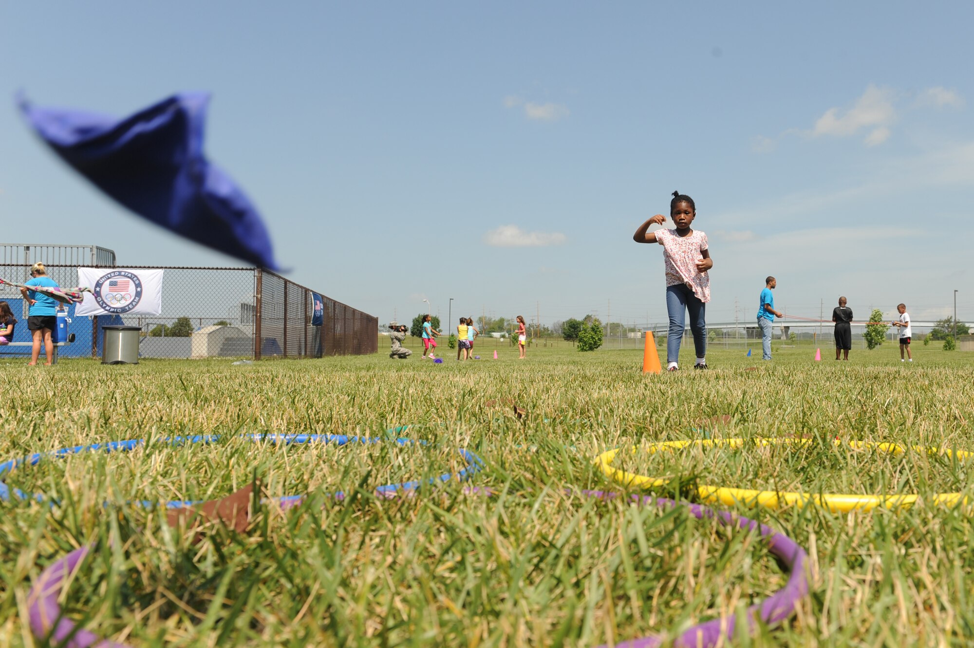Makaile Miller tosses a bean bag toward five rings during the 2014 Olympic Celebration at Scott Air Force Base, Ill., June 18, 2014.  Each ring had a different point value, and the children competed to get the highest score.  Throughout the week, participants competed in a variety of challenges, including shot put, relays and distance tosses.  (U.S. Air Force photo by Staff Sgt. Maria Bowman)