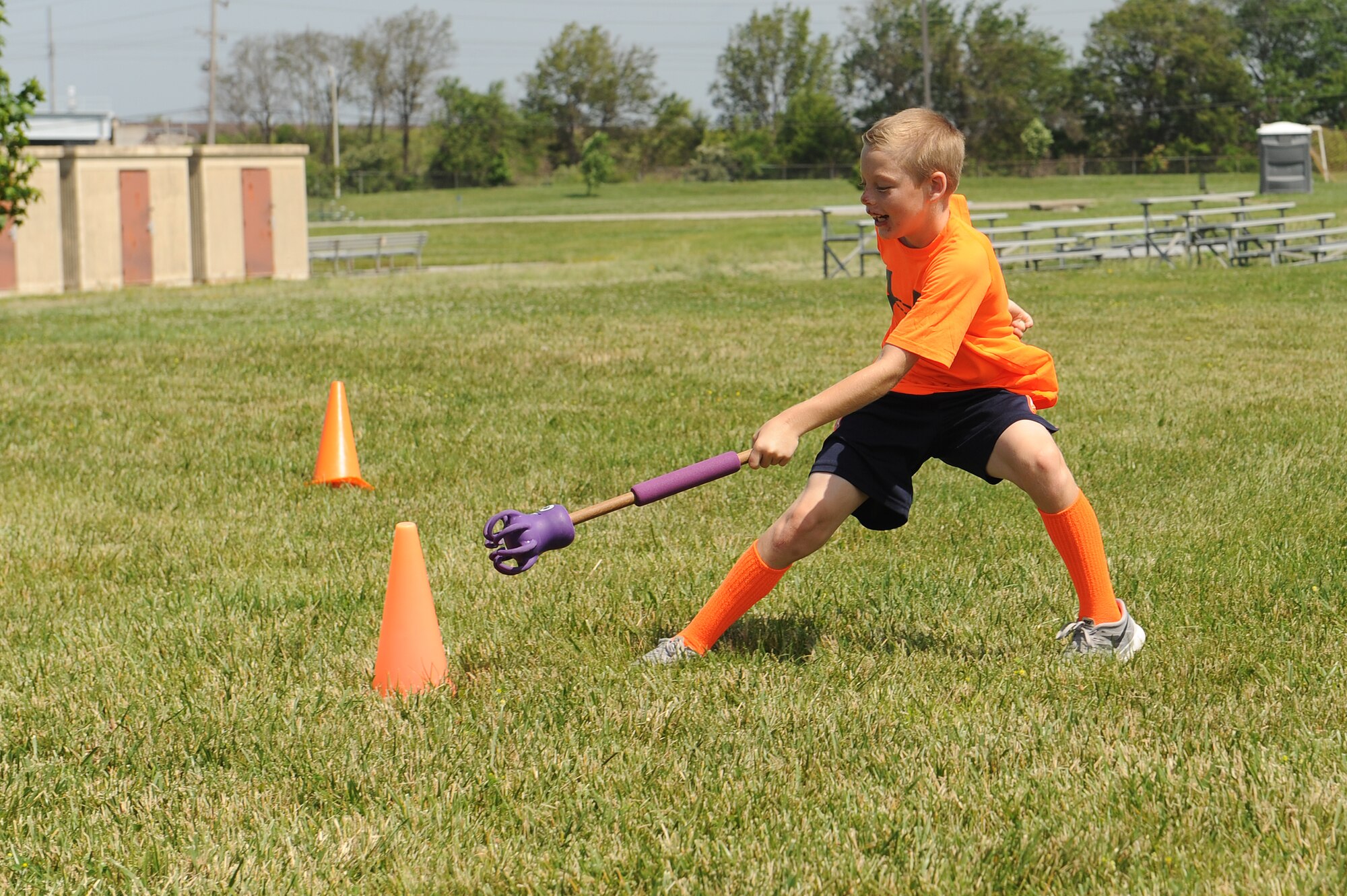 Ethan Crouse runs a relay race during at Scott Air Force Base, Ill., June 18, 2014.  The Youth Center organized this event to foster an appreciation of the Olympic Games and get them excited to compete as a team and as an individual.  (U.S. Air Force photo by Staff Sgt. Maria Bowman)
