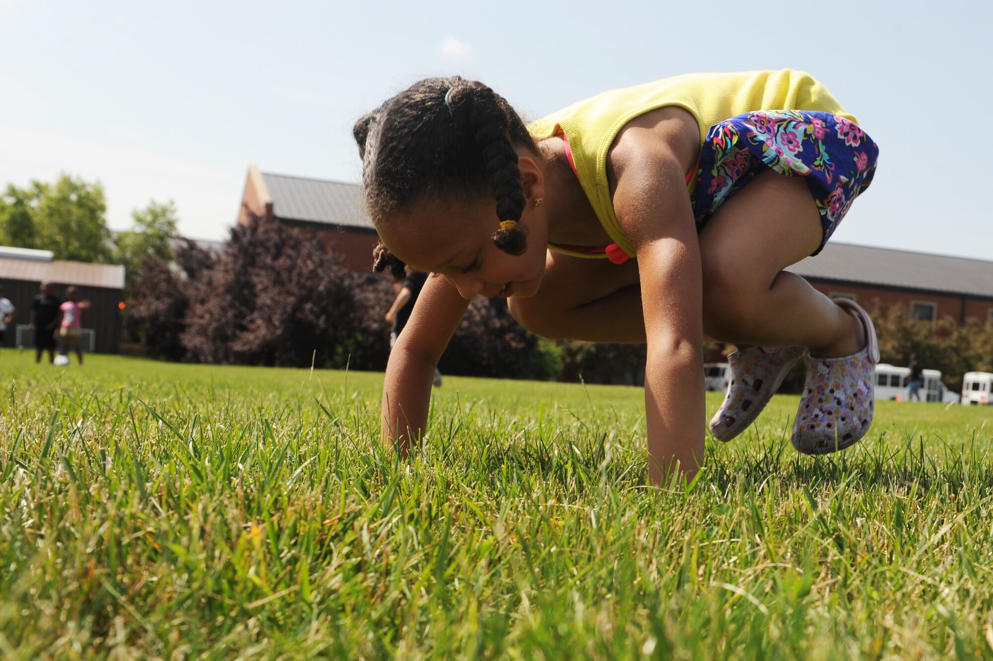 Aidyn Jones does push-ups as fast as she can in a race during the Youth Center’s 2014 Olympic Celebration at Scott Air Force Base, Ill., June 18, 2014.  This competition motivated the children to get physical and play outdoor games.  These activities emphasized fitness and the Olympic ideals, such as sportsmanship, fair play, respect and perseverance. (U.S. Air Force photo by Staff Sgt. Maria Bowman)