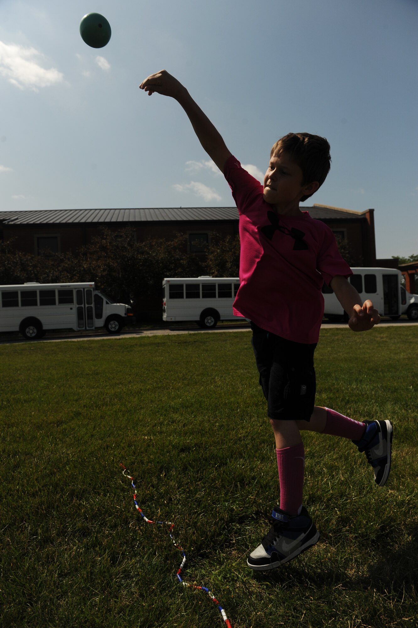 Joey Aamodt competes in shot put at the Youth Center during the 2014 Olympic Celebration at Scott Air Force Base, Ill., June 18, 2014.  Children participated in a variety of challenges including relay races and bean bag tosses.  During the closing ceremony, Ed Cockrell gave the children a motivational speech about the importance of sportsmanship and the Olympics.  Cockrell won a silver medal in shot put during the Athens Olympics in 2004.  (U.S. Air Force photo by Staff Sgt. Maria Bowman)