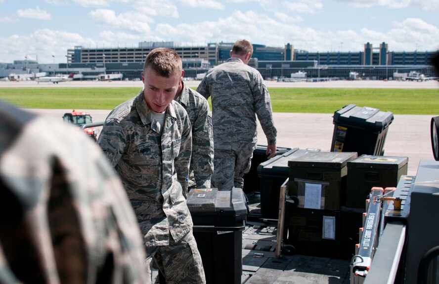 U.S. Air Force Airman 1st Class Glenn Lawhon, 219th Red Horse Squadron, helps load tools onto a KC-135R for a humanitarian deployment to Croatia in St. Paul, Minn., June 15, 2014. Croatia is a Minnesota State Partner under the National Guard State Partnership Program. (U.S. Air National Guard photo by Staff Sgt. Austen Adriaens/Released)