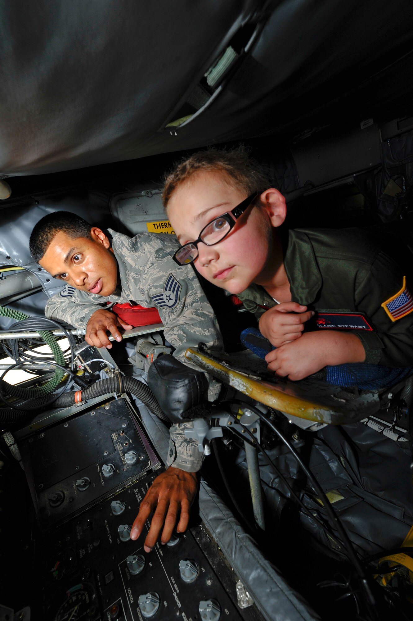 Staff Sgt. Kenneth Alvarez, 22nd Aerospace Maintenance Squadron crew chief, shows Claire Stewart the boom pod of a KC-135 Stratotanker, June 20, 2014, at McConnell Air Force Base, Kan. Claire was selected for the ‘Pilot for a Day’ program through a partnership with Wesley Medical Center, Wichita, Kan. She joined the McConnell community to see its daily operations and be an honorary member of the 350th Air Refueling Squadron. (U.S. Air Force photo/Airman 1st Class John Linzmeier)
