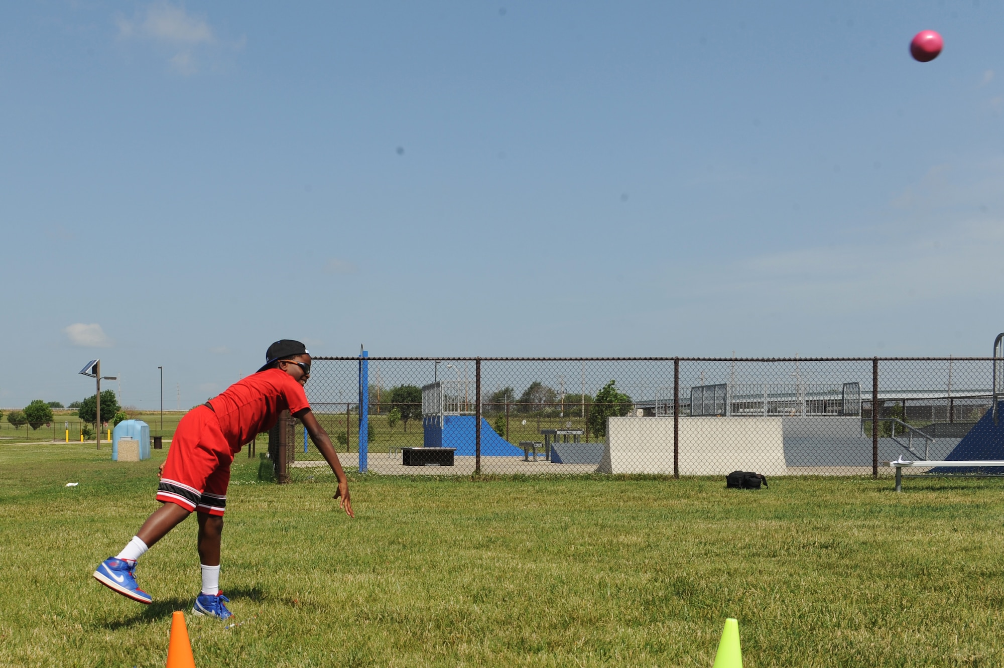 Wendell Miller competes in shot put at the Youth Center during the 2014 Olympic Celebration at Scott Air Force Base, Ill., June 18, 2014.    This event taught participants about different countries and competitors who attended Olympics, and provided them an opportunity to try a variety of activities. Children participated in a variety of challenges including relay races and bean bag tosses.  (U.S. Air Force photo by Staff Sgt. Maria Bowman)