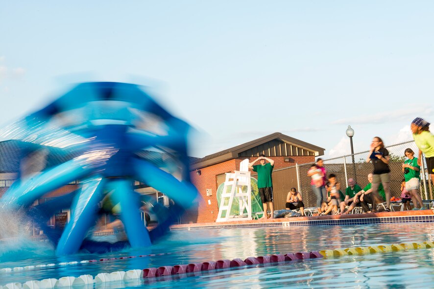 U.S. Air Force Airman 1st Class Reniro Viguilla, 23d Aerospace Medicine Squadron dental technician, races across a pool using an inflatable water wheel during the water wheel challenge at Moody Air Force Base, Ga., June 19, 2014. During the challenge, Airmen competed for the fastest time by running across the pool and back. (U.S. Air Force photo by Senior Airman Douglas Ellis/Released)