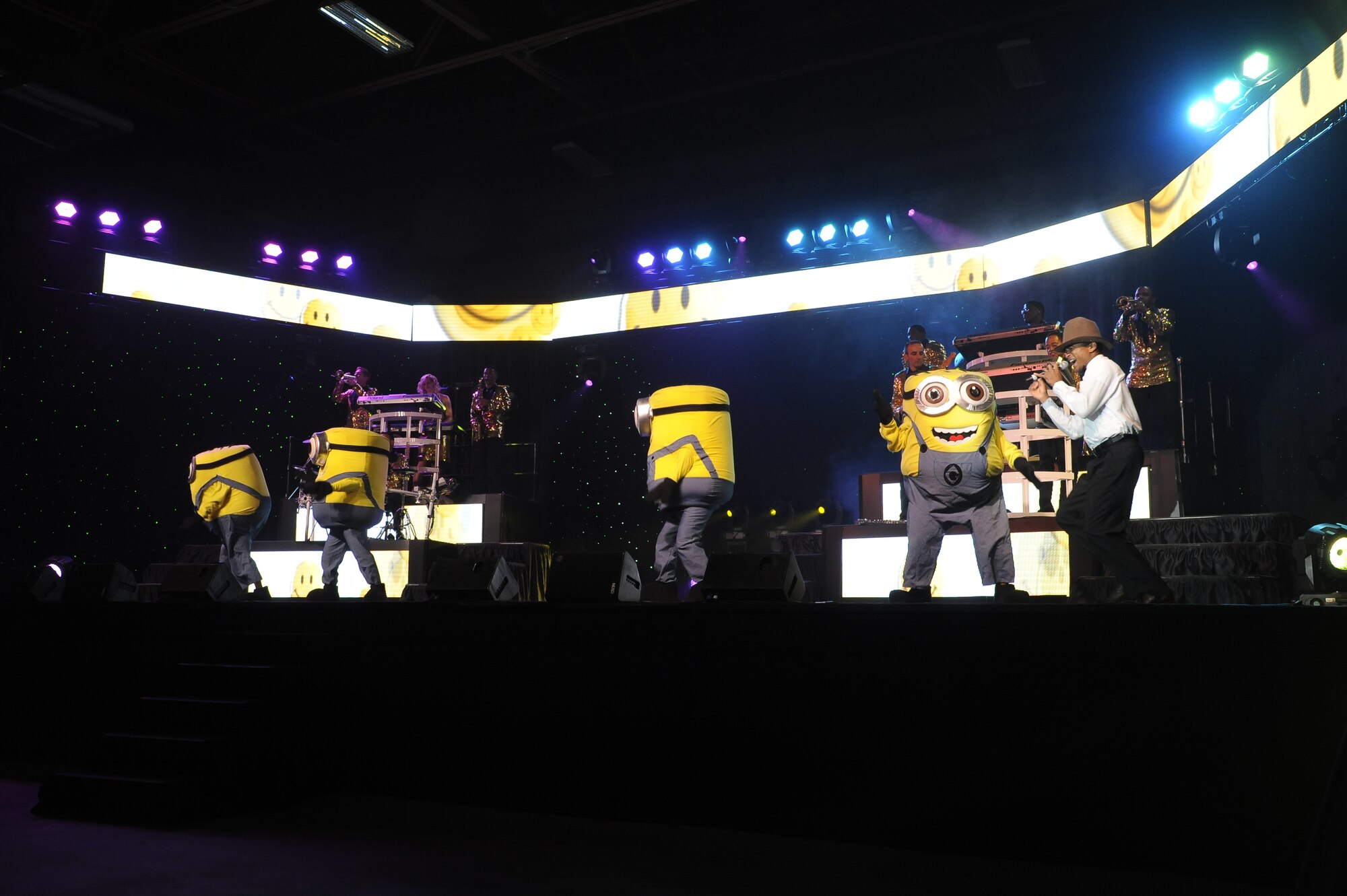 Tops in Blue members dress up as minions from the movie “Despicable Me” during a song performed at the Montana Expopark in Great Falls on June 23. During parts of the show TIB members dressed up as characters from classic Disney movies such as “Beauty and the Beast” and “Frozen”.  (U.S. Air Force photo/Airman 1st Class Collin Schmidt)
