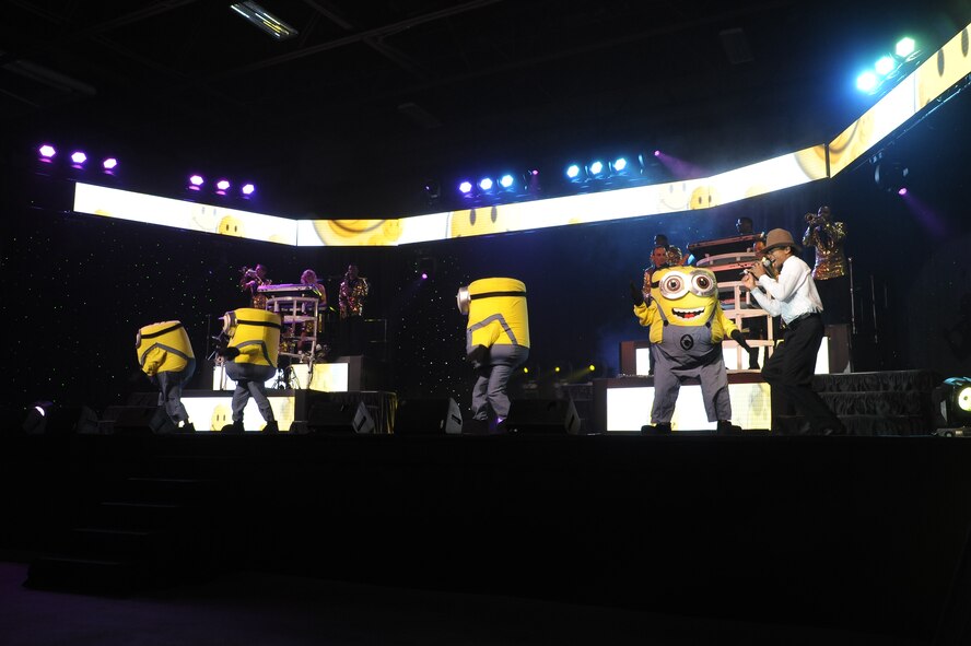 Tops in Blue members dress up as minions from the movie “Despicable Me” during a song performed at the Montana Expopark in Great Falls on June 23. During parts of the show TIB members dressed up as characters from classic Disney movies such as “Beauty and the Beast” and “Frozen”.  (U.S. Air Force photo/Airman 1st Class Collin Schmidt)