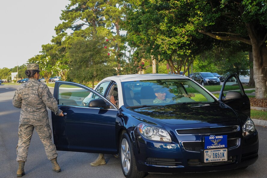 U.S. Air Force Airman 1st Class Reniro Viguilla, 23d Aerospace Medicine Squadron dental technician, exits the 23d Wing commander’s staff vehicle at Moody Air Force Base, Ga., June 25, 2014. Viguilla received a ride to work from Col. Chad Franks, 23d Wing commander, as a reward for beating his time in a water wheel challenge. (U.S. Air Force photo by Airman 1st Class Alexis Millican/Released)