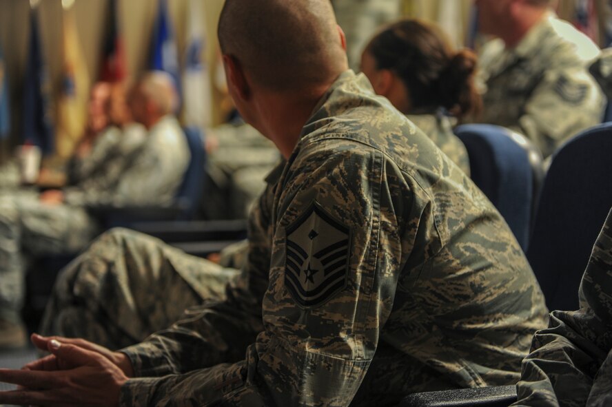 A first sergeant listens as participants of a First Sergeant Symposium are given certificates of completion at Moody Air Force Base, Ga., June 18, 2014. The First Sergeant Symposium helps technical and master sergeants learn about what it takes to be a first sergeant. (U.S. Air Force photo by Air Force Airman 1st Class Alexis Millican/Released)