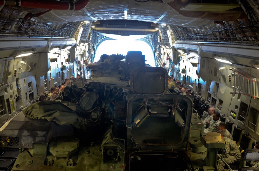 U.S. Army Soldiers with the 5th Battalion, 20th Infantry Regiment, 3-2 Stryker Brigade Combat Team, 7th Infantry Division, prepare a C-17 Globemaster III for takeoff during a training exercise June 19, 2014, at Joint Base Lewis-McChord, Wash. The training allowed Soldiers and Airmen to work together and practice loading and unloading Strykers. (U.S. Army photo/Staff Sgt. Justin Naylor)
