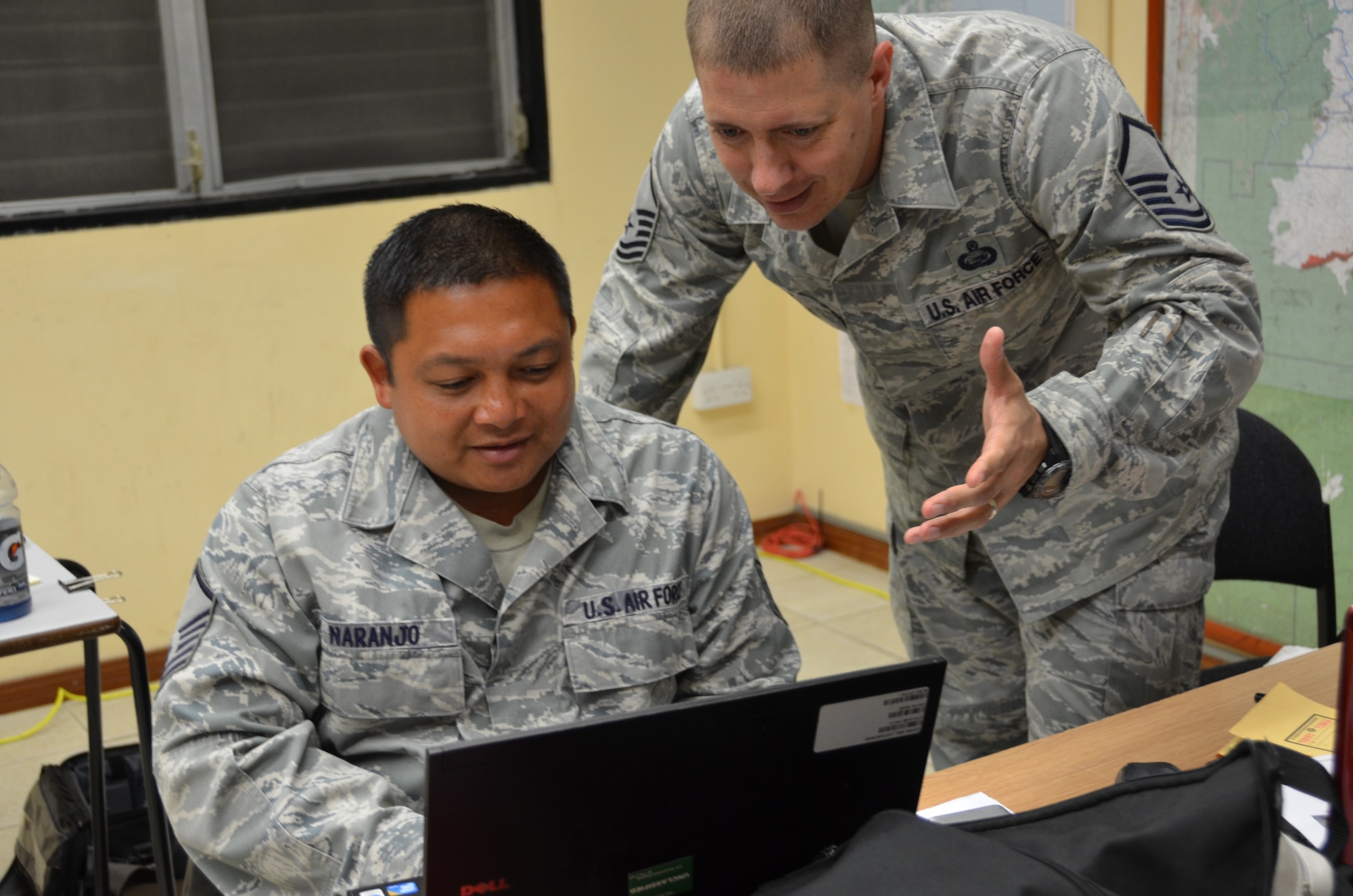 USAF Master Sgt. George Wolf (right), New Horizons Tactical Operations Center/PERSCO superintendent, discusses personnel accountability with Master Sgt. Reggie Naranjo (left), New Horizons Services superintendent, June 24, 2014, in Ladyville, Belize.


