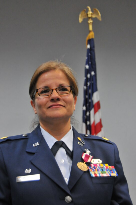 Maj. Graciela Scambiaterra, the operations officer for the 126th Force Support Squadron, attached to the 126th Air Refueling Wing, stands at attention during the reading of her retirement orders at Scott Air Force Base, Ill., June 8, 2014. Scambiaterra spent 23 years in the Illinois Air National Guard. (Air National Guard photo by Staff Sgt. Andrew Kleiser)