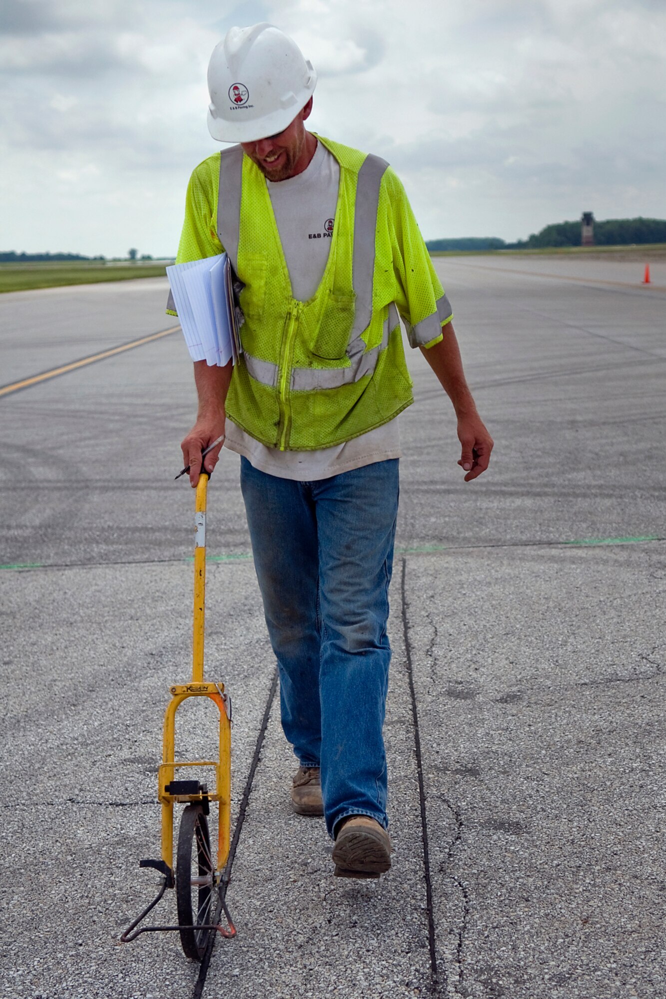 Mike Lechner, a contractor working on the runway at Grissom Air Reserve Base, Ind., uses a measuring wheel to document the position of expansion joints on a taxiway at the north-central Indiana base June 20, 2014. According to the U.S. Army Corps of Engineers, Grissom?s runway construction is on track to meet its July 15 deadline to reopen the airfield. (U.S. Air Force photo/Tech. Sgt. Mark R. W. Orders-Woempner)