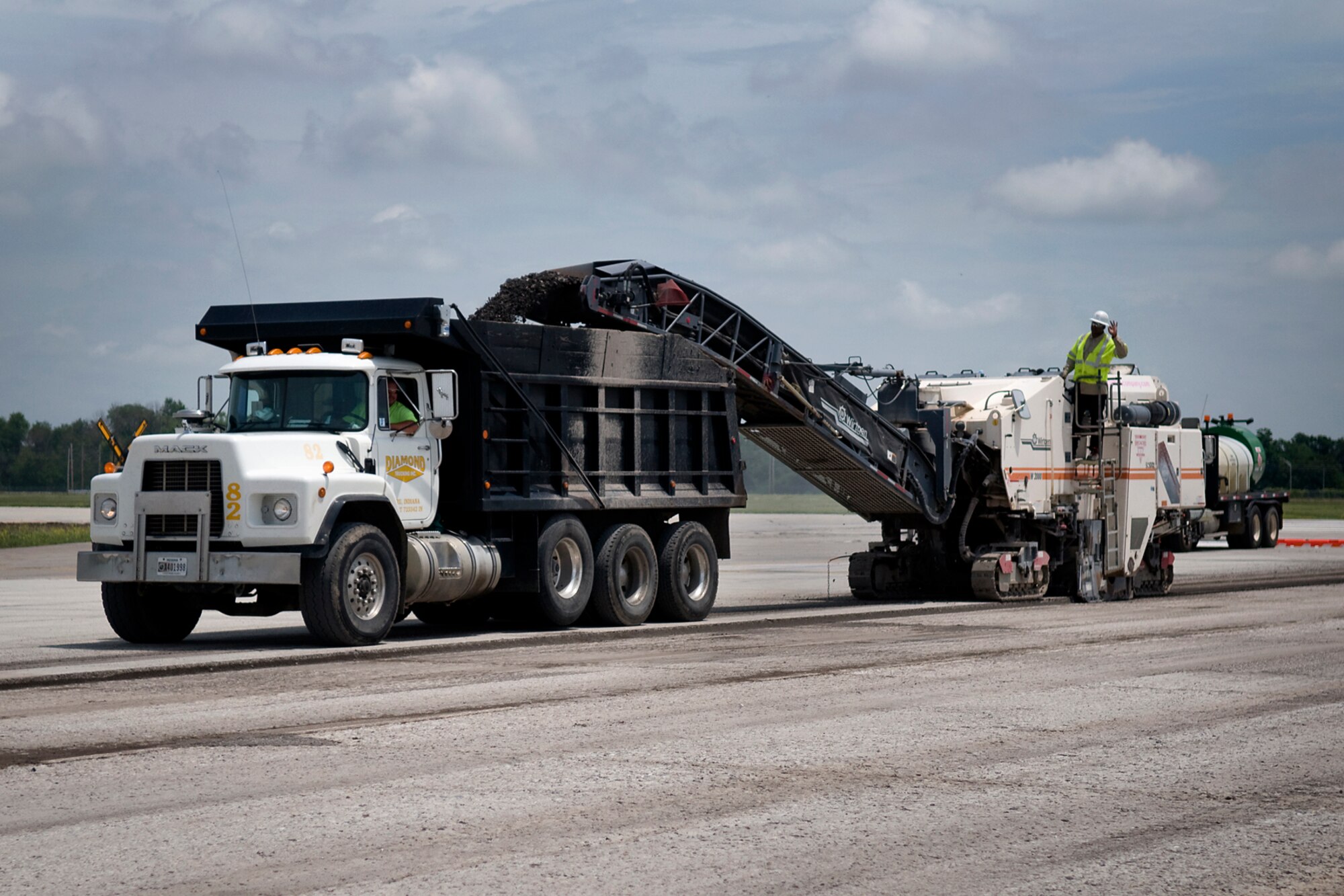 Contractors working on the runway at Grissom Air Reserve Base, Ind., use a milling machine to remove old and damaged pavement on a taxiway at the north-central Indiana base June 20, 2014. Six one-inch expansion joints are being replaced and parts of the runway and taxiway surfaces are being repaved. (U.S. Air Force photo/Tech. Sgt. Mark R. W. Orders-Woempner)