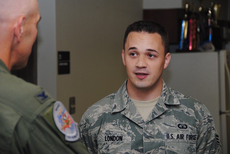 VANCE AIR FORCE BASE, Okla. – Senior Airman Matt London, a 5-level air traffic controller with the 71st Operations Support Squadron, speaks with Col. Clark Quinn, the 71st Flying Training Wing commander, June 23, in the Radar Approach Control break room after being recognized as the Airman of the Month. London received a coin from the colonel in front of his peers who packed the room. (U.S. Air Force photo/ Joe B. Wiles)