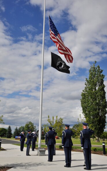 Members of the Team Fairchild Honor Guard perform a ceremonial retreat at Fairchild Air Force Base, Wash., June 24, 2014. The ceremony was held in remembrance of the B-52 Stratofortress crash that took the lives of four Fairchild Airmen in 1994. (U.S. Air Force photo by Senior Airman Mary O'Dell/Released)