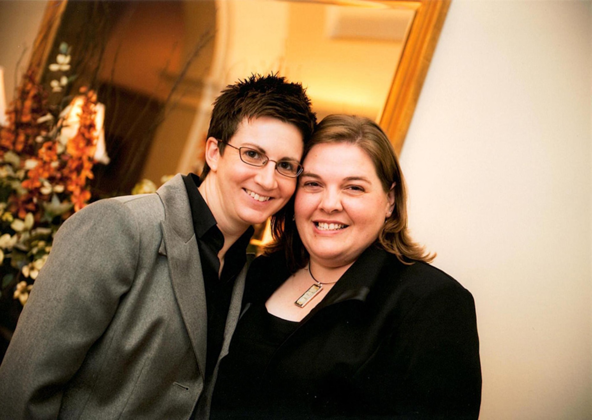 Master Sgt. Angela Caruso-Yahne, 34th Aeromedical Evacuation Squadron, Peterson Air Force Base, Colorado, (left) and her spouse, Mandy, pose for a photo at a friend's wedding. The two legally married July 2013, one month after the repeal of the Defense of Marriage Act and 14 years after their unofficial wedding. Approaching their sixth deployment together, the couple attended their first Yellow Ribbon event this year. (Courtesy photo)
