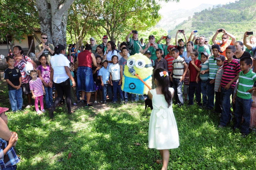 A girl from the village of Proterillos swings at a pinata while the other kids anxiously wait for the candy to fall.  Nearly 130 members of Joint Task Force-Bravo, with the support of Joint Task Force-Bravo’s Joint Security Forces, completed a volunteer five mile round trip hike to deliver more than 4,000 pounds of food, supplies and clothing to families in need in the mountain village of Proterillos outside La Paz, Honduras, June 21, 2014.  The effort was part of the 55th Joint Task Force-Bravo Chapel Hike, a venerable tradition during which the servicemembers donate money to purchase food and supplies and then carry them on a hike through the mountains to deliver to local, underserviced communities.  (Photo by U. S. Air National Guard Capt. Steven Stubbs)