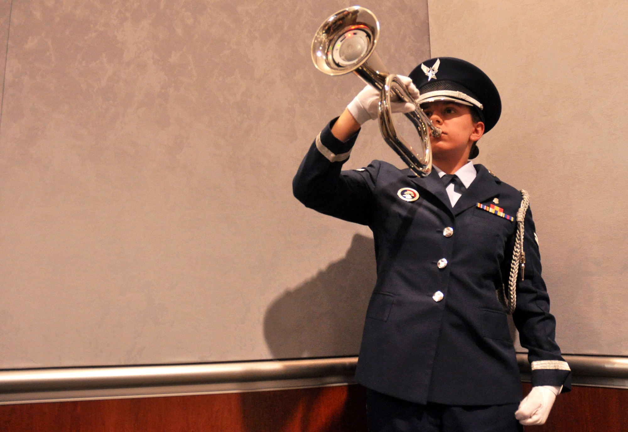 Honor Guard Bugler, Airman 1st Class Sabrina Bailey, plays “Taps” following the one minute moment of silence during the Khobar Towers memorial ceremony June 25 at Eglin Air Force Base, Fla.  The ceremony marks the 18th anniversary of the tragic bombing that killed 19 service members including 12 33rd Fighter Wing Airmen. Each year a ceremony is held by the Nomads to commemorate their brothers who’ve “ceased their wandering.” Due to inclement weather, the ceremony was moved indoors. (U.S. Air Force photo/Ilka Cole)