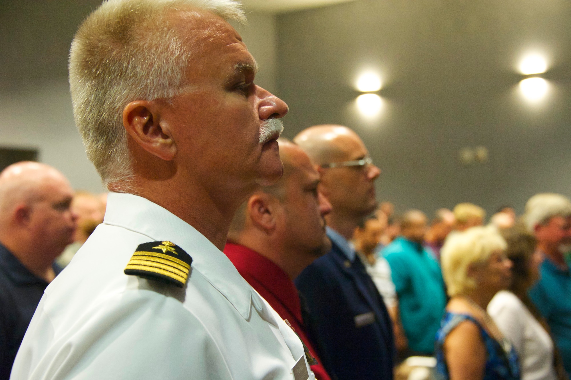 Navy Capt. Paul Haas, the 33rd Fighter Wing vice commander, honors a moment of silence for the 19 fallen Airmen at the Khobar Towers memorial ceremony June 25 at Eglin Air Force Base, Fla. The ceremony marks the 18th anniversary of the tragic bombing that killed 19 service members, including 12 33rd FW Airmen. Each year a ceremony is held by the Nomads to commemorate their brothers who’ve “ceased their wandering.”  (U.S. Air Force photo/Sara Vidoni)