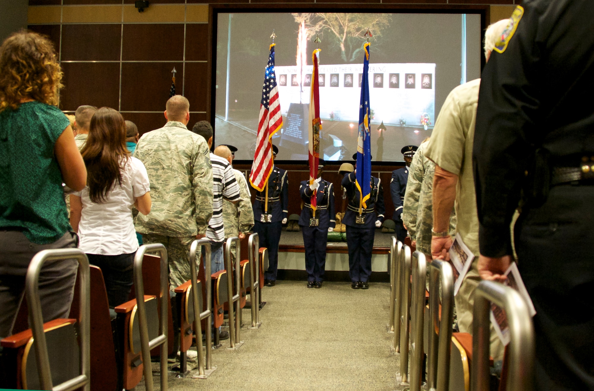 The Eglin Air Force Base honor guard commences the Khobar Towers memorial ceremony with the presentation of colors June 25 at the 33rd Fighter Wing. The ceremony marks the 18th anniversary of the tragic bombing that killed 19 service members, including 12 33rd FW Airmen. Each year a ceremony is held by the Nomads to commemorate their brothers who’ve “ceased their wandering.” Due to inclement weather, the ceremony was moved indoors. (U.S. Air Force photo/Sara Vidoni)