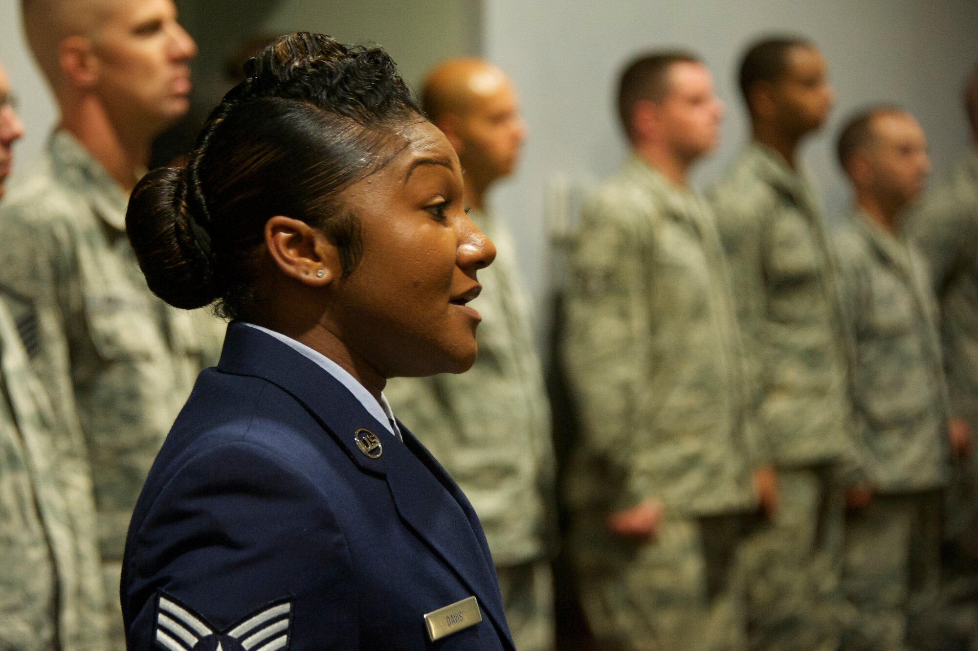 Senior Airman Gwenn Davis, of the 33rd Fighter Wing, sings the national anthem at the Khobar Towers memorial ceremony June 25 at Eglin Air Force Base, Fla. The ceremony marks the 18th anniversary of the tragic bombing that killed 19 service members including 12 33rd FW Airmen. Each year a ceremony is held by the Nomads to commemorate their brothers who’ve “ceased their wandering.” (U.S. Air Force photo/Sara Vidoni)