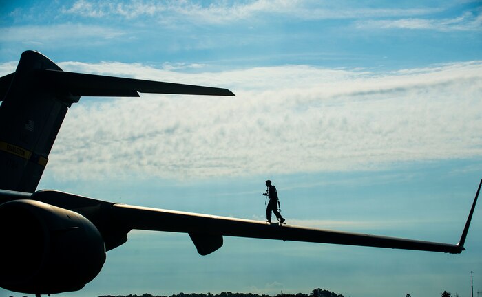 Airman 1st Class Matt Sinclair, 437th Aircraft Maintenance Squadron crew chief, inspects a Globemaster III C-17 wing, June 24, 2014, at Joint Base Charleston, S.C. The maintainers perform daily checks and maintenance to ensure the aircraft are ready to fly. (U.S. Air Force photo/Senior Airman George Goslin)