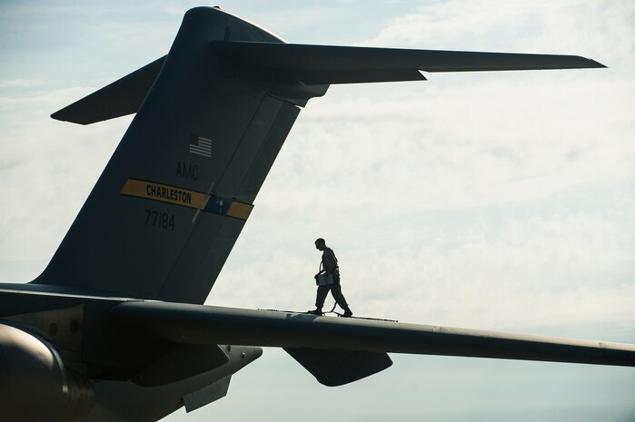 Airman 1st Class Matt Sinclair, 437th Aircraft Maintenance Squadron crew chief, inspects a Globemaster III C-17 wing, June 24, 2014, at Joint Base Charleston, S.C. The maintainers perform daily checks and maintenance to ensure the aircraft are ready to fly. (U.S. Air Force photo/Senior Airman George Goslin)