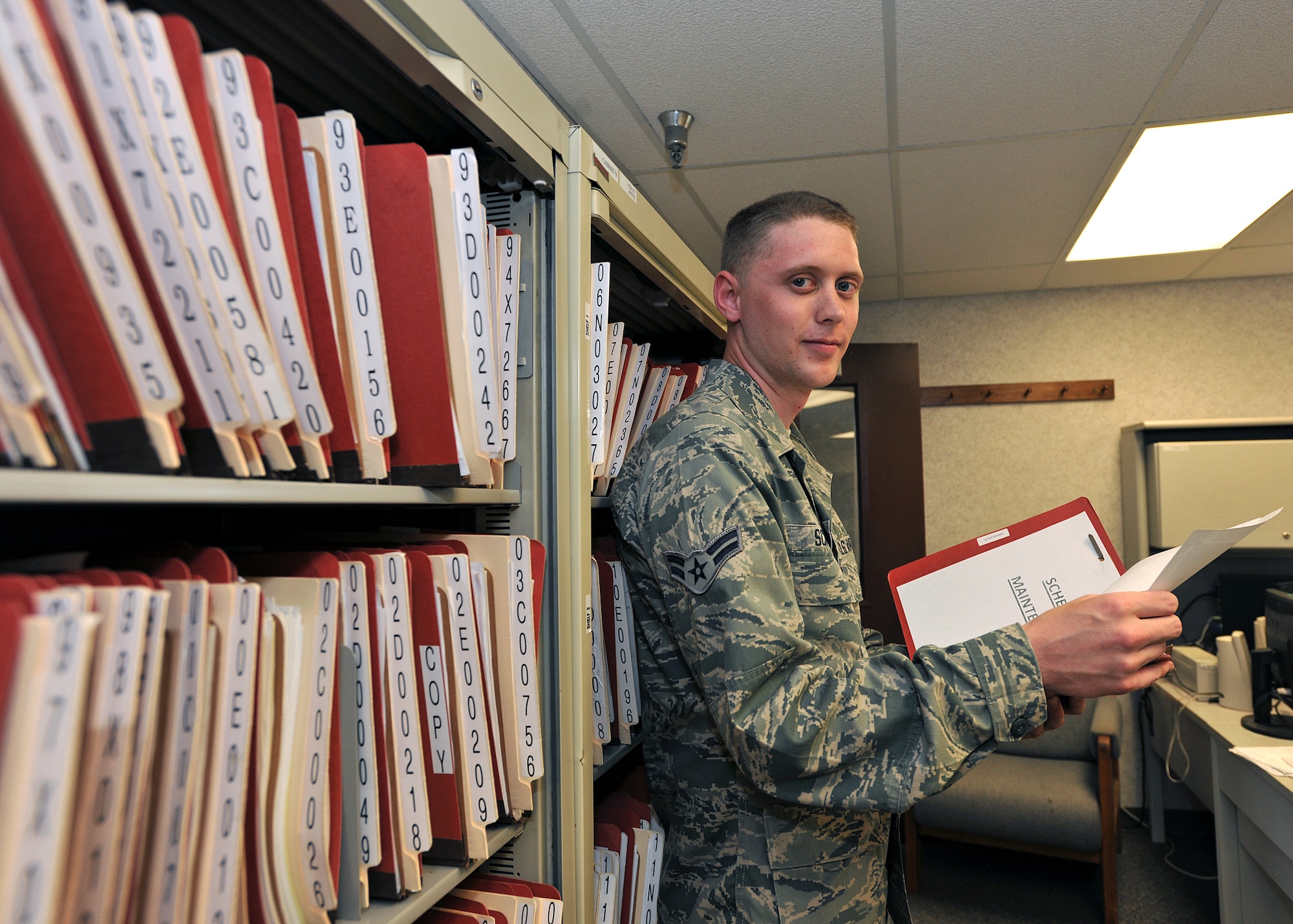 Airman 1st Class Jared Scheel, 319th Logistics Readiness Squadron vehicle management and analysis journeyman, reviews records from vehicle reports on Grand Forks Air Force Base, N.D., June 18, 2014. Scheel, a Vancouver, Wash., native, was named Warrior of the Week for the fourth week of June 2014. (U.S. Air Force photo/Senior Airman Xavier Navarro)