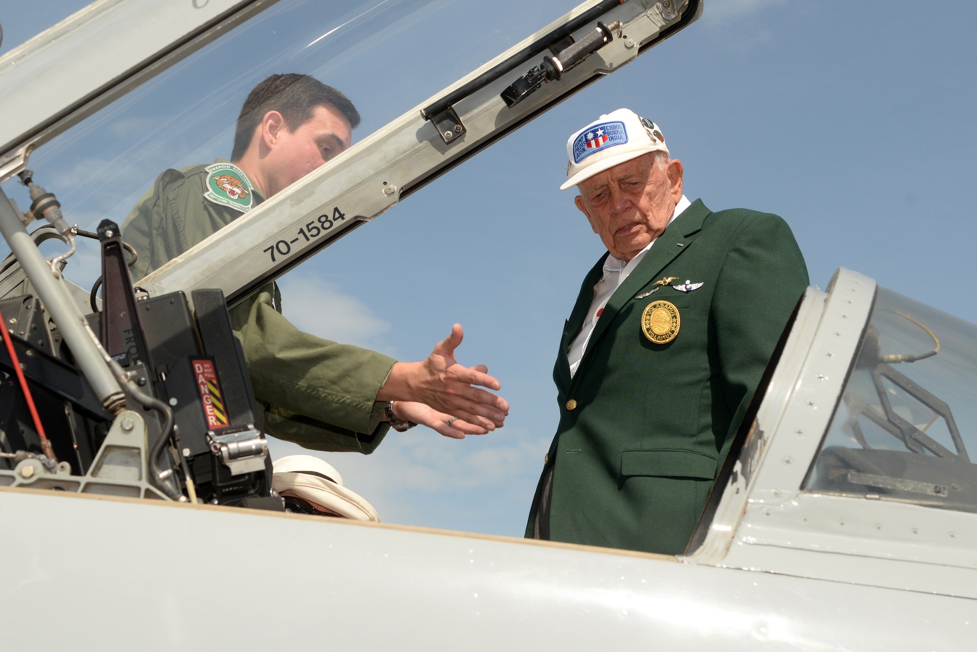 Capt. Erik Lugo-Escobar (left), 560th Flying Training Squadron, describes capabilities of a T-38 Talon to Jim Calvert June 20 at Joint Base San Antonio-Randolph. Thirteen ace pilots visited Joint Base San Antonio-Randolph June 20. The American Fighter Aces Association was founded in 1960 to recognize the 1,450 combat pilots who received the special distinction of becoming an ace by destroying five or more hostile aircraft in air-to-air combat. (U.S. Air Force photo by Johnny Saldivar)