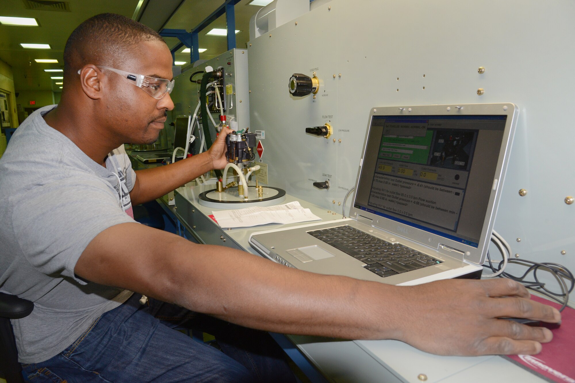 Jason Jenkins troubleshoots and runs tests on an 0393 oxygen regulator in the Air Force’s only Oxygen Maintenance Depot. (Air Force photo by Kelly White)