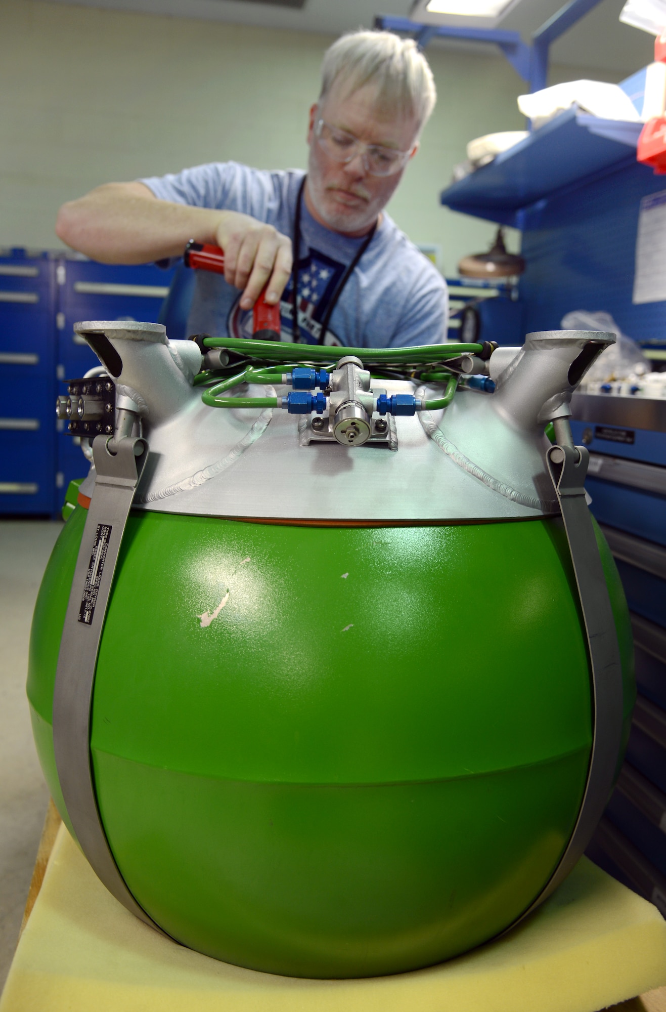 Curtis James works on an E-3 Oxygen Converter, which holds 75L of liquid oxygen, or LOX, in the Oxygen Maintenance Depot in Bldg. 1055. (Air Force photo by Kelly White)